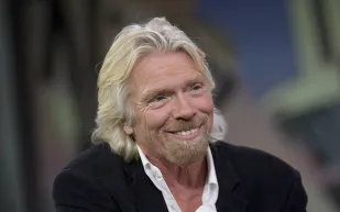 ما هو الحل السحري الذي اقترحه ريتشارد برانسون لمشكلة عدم المساواة في الدخل؟