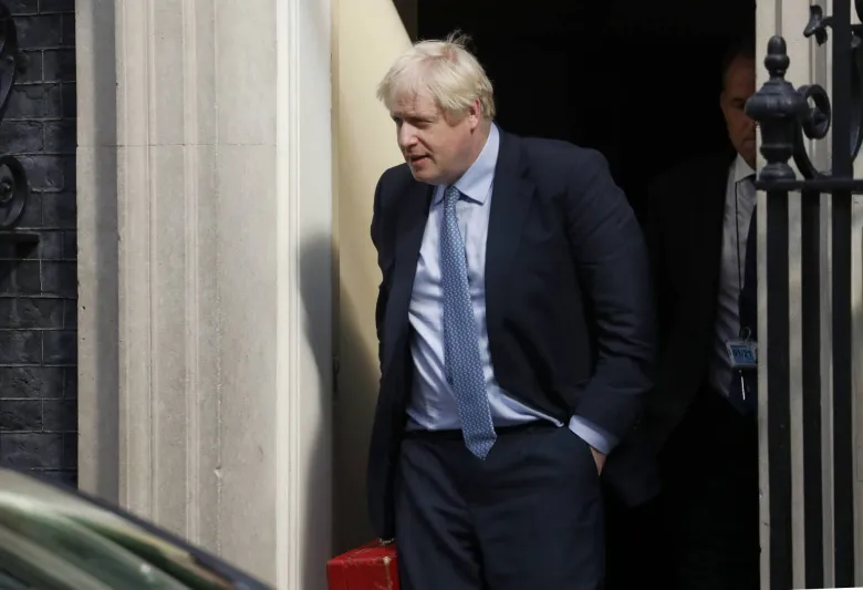 بدلة وحقيبة وخوذة.. شاهد رئيس وزراء بريطانيا يجوب شوارع لندن بالدراجة الهوائية